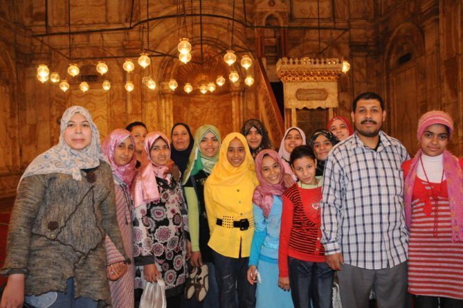 people attending the mosque- tourists taking a photo