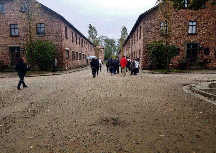 uschwitz death camp, auschwitz concentration camp visitors are walking in silence
