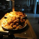 A plate piled high with assorted pastries on a kitchen counter.